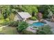 Aerial view of a backyard pool featuring a spa, waterfall and an outdoor structure with light colored wood at 1385 Gordon Rd, Moreland, GA 30259