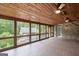 Large covered porch overlooking a pool, hot tub and lush green backyard at 1385 Gordon Rd, Moreland, GA 30259