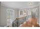 Elegant staircase with wood and wrought iron banister leads to the upper level at 1385 Gordon Rd, Moreland, GA 30259