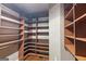 Organized walk-in closet featuring ample shelving, hanging racks, and wooden floors at 1385 Gordon Rd, Moreland, GA 30259