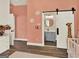Adorable Bedroom featuring pink walls, wood-look tile flooring, and barn door to the bathroom at 340 Cedar St, Social Circle, GA 30025