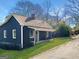 Quaint home with blue siding and a covered front porch, surrounded by lush greenery at 340 Cedar St, Social Circle, GA 30025