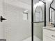 Modern walk-in shower featuring white tile and glass doors at 340 Cedar St, Social Circle, GA 30025