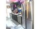 Finished basement bar with stainless steel appliances, black cabinets, and baseball themed decor at 130 Victoria Pl, Fayetteville, GA 30214