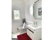 Bright bathroom with modern vanity, statement mirror, and stained glass window at 130 Victoria Pl, Fayetteville, GA 30214