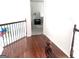 Hallway with hardwood flooring leads to a bedroom with neutral decor and lots of natural light at 130 Victoria Pl, Fayetteville, GA 30214