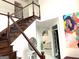 Hallway with modern staircase, accent art, and a clear view into the living room at 130 Victoria Pl, Fayetteville, GA 30214
