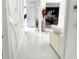 Hallway featuring marble floors and wall accents leading to a modern kitchen at 130 Victoria Pl, Fayetteville, GA 30214