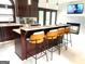 Kitchen island with barstool seating, stainless appliances, and modern lighting at 130 Victoria Pl, Fayetteville, GA 30214