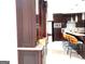 Kitchen with dark wood cabinets, island with seating, and stainless steel appliances at 130 Victoria Pl, Fayetteville, GA 30214
