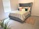 Bedroom featuring a tufted headboard bed, plush rug and lots of natural light at 130 Victoria Pl, Fayetteville, GA 30214