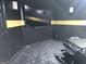Media room with black walls, gold trim, large screen TV and modern seating at 130 Victoria Pl, Fayetteville, GA 30214