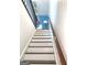 Staircase with white risers and dark stained wood treads and handrail at 130 Victoria Pl, Fayetteville, GA 30214