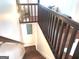 Wooden staircase leading down with dark wood handrail at 130 Victoria Pl, Fayetteville, GA 30214