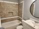 Bathroom features a bathtub, vanity with a sink, stylish mirror, and warm-toned tile work, creating a cozy space at 615 Cofield Dr, Hapeville, GA 30354