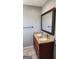 Bathroom featuring a vanity with double sinks, granite countertops, and a framed mirror, offering modern style at 615 Cofield Dr, Hapeville, GA 30354