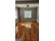 Sun-filled bedroom showcasing hardwood floors and a large window, creating a warm and inviting atmosphere at 615 Cofield Dr, Hapeville, GA 30354