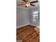 Bedroom with hardwood floors, ceiling fan, and natural light, offering a comfortable and welcoming space at 615 Cofield Dr, Hapeville, GA 30354