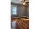 Bedroom with hardwood floors, ceiling fan, and natural light at 615 Cofield Dr, Hapeville, GA 30354