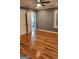 Bedroom with hardwood floors, neutral paint, and a view into the bathroom, creating a cozy space at 615 Cofield Dr, Hapeville, GA 30354