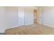 A bedroom featuring neutral carpet and light-colored walls with one door open to a hallway at 504 Alford Cv # 90, Fairburn, GA 30213