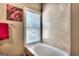 Bathtub and decorative tile wall with window and privacy blinds at 2804 Dominion Nw Ln # Bldg 2, Kennesaw, GA 30144