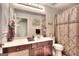 Bathroom with dark wood vanity, decorative mirror, and shower-tub combo at 2804 Dominion Nw Ln # Bldg 2, Kennesaw, GA 30144