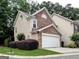 Side exterior view of a well-maintained townhome with stone accents and lush landscaping at 2804 Dominion Nw Ln # Bldg 2, Kennesaw, GA 30144