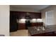 Modern kitchen with granite countertops, stainless steel appliances, and dark wood cabinets at 2804 Dominion Nw Ln # Bldg 2, Kennesaw, GA 30144