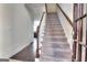 Staircase leading to the second floor with wood railing and carpet at 2804 Dominion Nw Ln # Bldg 2, Kennesaw, GA 30144