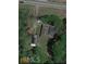 An aerial view of the property shows the home, sheds, and the surrounding trees at 10142 Washington Street, Covington, GA 30014