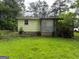 Exterior view of a home with a wooden deck, surrounded by a well-manicured lawn at 22 Shell Rd, Carrollton, GA 30116