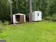 Two backyard sheds offer storage solutions in a serene wooded environment at 22 Shell Rd, Carrollton, GA 30116