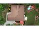 Aerial view of a home showcasing a backyard pool, patio area, and pristine landscaping in a serene setting at 55 Ashton Pl, Covington, GA 30016