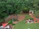 Aerial view of landscaped yard with firepit, storage shed, and inviting outdoor seating arrangement at 55 Ashton Pl, Covington, GA 30016