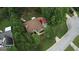 Aerial view highlights the property's backyard with a deck, patio, and mature trees at 55 Ashton Pl, Covington, GA 30016