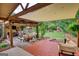 Inviting backyard with a covered patio, wood deck, lush lawn, and mature trees creating a private oasis at 55 Ashton Pl, Covington, GA 30016