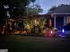 Backyard at dusk featuring a covered patio and grilling area with landscape lighting and plants at 55 Ashton Pl, Covington, GA 30016