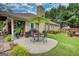 Well-maintained backyard with a spacious patio, built-in grill, and green umbrella for outdoor entertaining and relaxation at 55 Ashton Pl, Covington, GA 30016