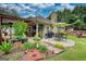 Beautifully landscaped backyard with a patio, lush greenery, and mature trees offering a serene outdoor setting at 55 Ashton Pl, Covington, GA 30016
