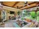 Cozy covered patio area features comfortable seating, ceiling fans, and a television for outdoor relaxation at 55 Ashton Pl, Covington, GA 30016