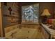 Bathroom highlighting a soaking tub, decorative accents, and natural light from the window at 55 Ashton Pl, Covington, GA 30016