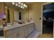 Bathroom featuring double sinks, white cabinetry, and a view of the bedroom, creating a spa-like retreat at 55 Ashton Pl, Covington, GA 30016