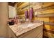 This powder room features a close up of a wood accent wall and granite countertop vanity at 55 Ashton Pl, Covington, GA 30016