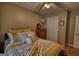Bedroom featuring a decorative wreath and a bed with yellow and gray patterned bedding at 55 Ashton Pl, Covington, GA 30016