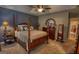 Bedroom with a four-poster bed, ceiling fan, and coordinated furniture set, creating a harmonious and relaxing space at 55 Ashton Pl, Covington, GA 30016