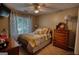 Cozy bedroom features a bed with yellow and gray patterned bedding and plenty of natural light from the window at 55 Ashton Pl, Covington, GA 30016