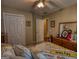 Bedroom featuring a bed with yellow and gray patterned bedding and large closet with plenty of storage space at 55 Ashton Pl, Covington, GA 30016