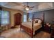 Spacious bedroom featuring a four-poster bed, ceiling fan, and an elegant dresser at 55 Ashton Pl, Covington, GA 30016