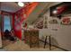 Finished bonus room with sports themed decor, a bar area, and a stationary bike creating a fun entertainment area at 55 Ashton Pl, Covington, GA 30016
